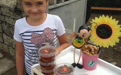 Who could turn down this sweetheart selling almonds soaking in honey? All grown or harvested locally, of course. (submitted by JimJ)