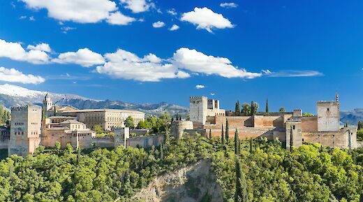 Trees, mountains, and fortresses in Alhambra, Spain. Unsplash@Getty Images