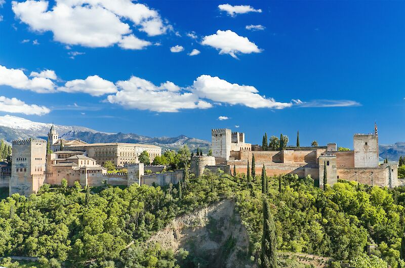 Trees, mountains, and fortresses in Alhambra, Spain. Unsplash@Getty Images
