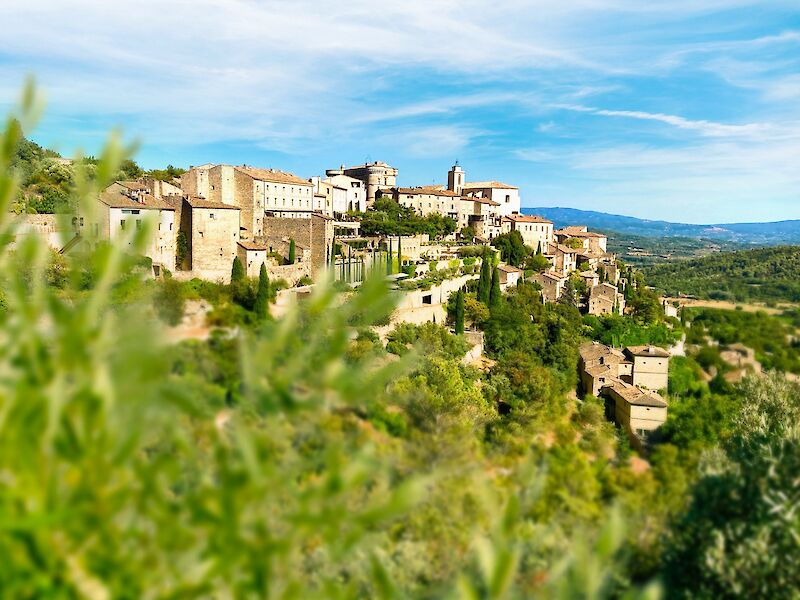 Gordes viewed through foliage, France. Unsplash@Sebastien Jermer
