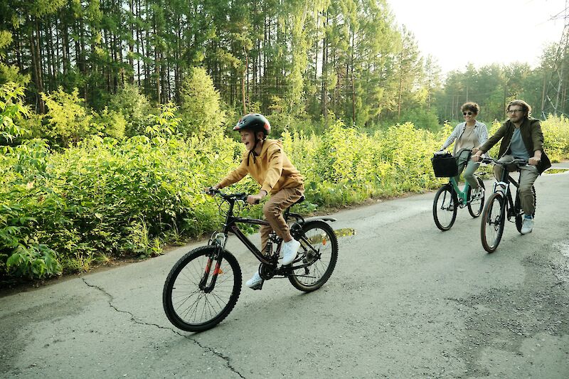 Child enjoying a bike ride with family. Getty Images@Unsplash