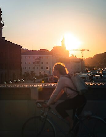 Cyclist on a bridge in Passau, Germany. Unsplash:Tim Baumeister