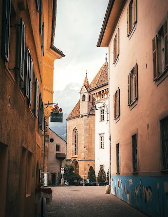 Orange buildings in Merano, Italy. Unsplash:Tobias Reich