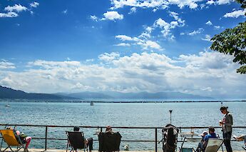 People relaxing on Lindau, Austria. Unsplash:Harry Dona