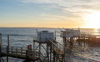 Carrelets at sunset, Royan, France. Unsplash:Matthieu Staelen