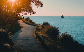 Cliff path at sunset, La Rochelle, France. Unsplash: Gautier Yrnhazrj