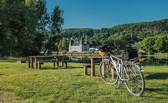 Bike parked by picnic benches, Via Rhona. Unsplash:Free Nomad