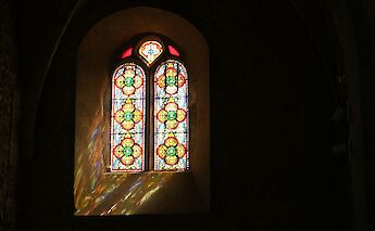 Stained glass window in Pérouges, France. Unsplash:Coda Studio