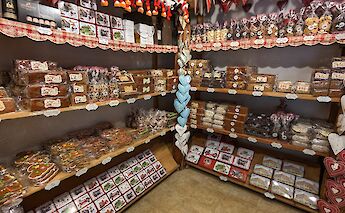 Shelves filled with a variety of traditional Alsatian gingerbread and sweets in a bakery.