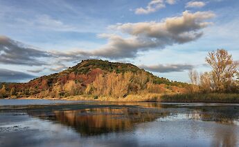 Hill reflected in Lac du Salagou, France. Flickr:Christian Ferrer