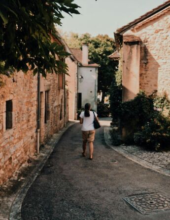 Walking down a road, Dordogne, France. Unsplash:Hannah Reding