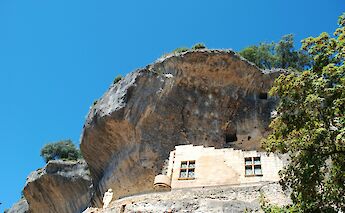 Windows in the cliff at Les Eyzies-de-Tayac-Sireuil, France. Unsplash:vigouroux gerald