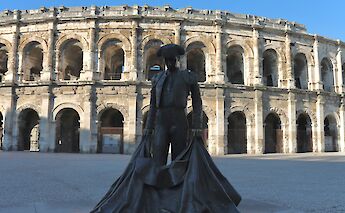 Matador statue outside the Aréne de Nimes, Nîmes, France. Unsplash:Hongbin