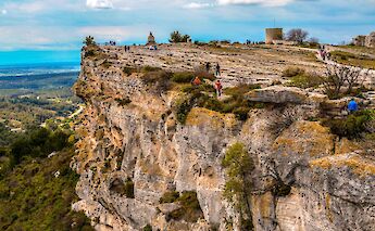 People hiking on the rocks, Les Baux de Provence, France. Unsplash:Hassan Anayi