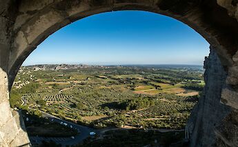 View of Les Baux de Provence through an archway, France. Unsplash:Jaakko Kemppainen