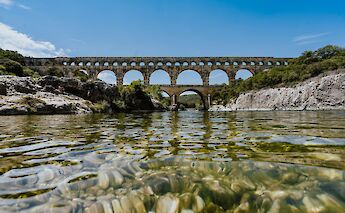 View of the Pont du Gard from the water, Nimes, France. Unsplash:Xuan Nguyen