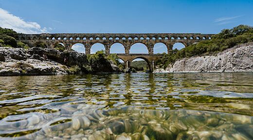View of the Pont du Gard from the water, Nimes, France. Unsplash:Xuan Nguyen