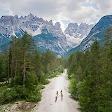 Cycling into a dramatic Dolomite valley surrounded by towering cliffs. -toFA