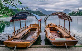 Boats (pletna) to take people on Lake Bled, Slovenia. Luis Ascenso@Flickr