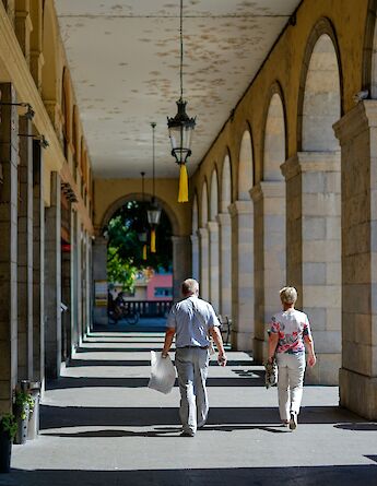 People walking through an arched corridor, Girona, Spain. Unsplash:Fikri Rasyid