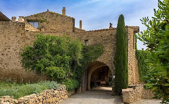Blue skies over a medieval building, Monells, Spain. Unsplash:Manuel Torres Garcia