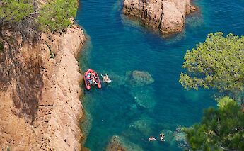 People swimming off the golden coast of Llafranc, Spain. Unsplash:Unexpected Catalonia