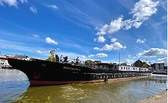 The boat named Princesse Royal is on a river with people onboard, set against a blue sky and white&hellip;