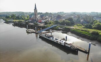 An aerial view of the Magnifique II docked by a small town with a prominent church and surrounding&hellip;