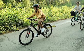 Family cycling near woodland. Getty Images@Unsplash