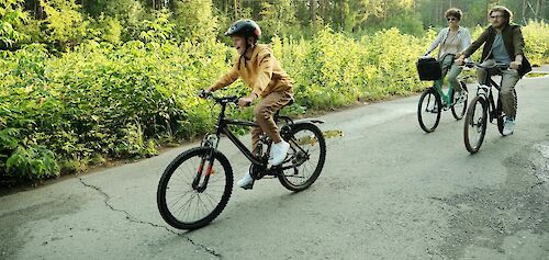 Family cycling near woodland. Getty Images@Unsplash