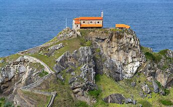 Orange-roofed building on San Juan de Gaztelugatxe, Spain. Unsplash:David Vives