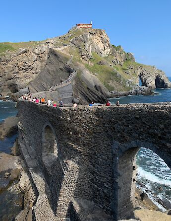 People walking around San Juan de Gaztelugatxe, Spain. Unsplash:Fran Fernandez