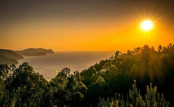 Sun setting at San Juan de Gaztelugatxe, Spain. Unsplash:Aitor Olaskoaga