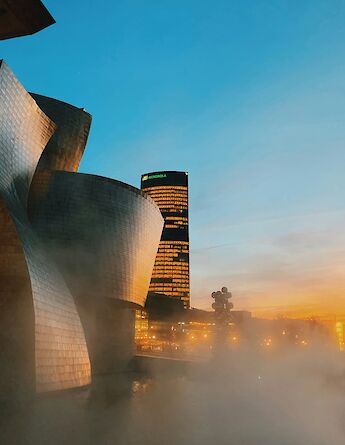 Mist around the Guggenheim Museum at sunset, Bilbao, Spain. Unsplash:Anastasiia Rozumna