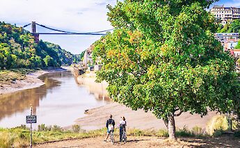 Admiring the Clifton Suspension Bridge on a bike tour of England. iStock@georgeclerk