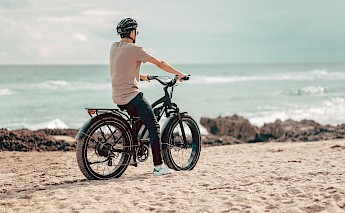 electric bike on beach. Unsplash: Himiway Bikes