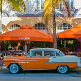 Orange car and cafes, Miami. Unsplash:Hector Falcon