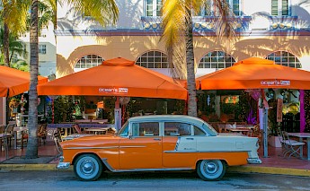 Orange car and cafes, Miami. Unsplash:Hector Falcon
