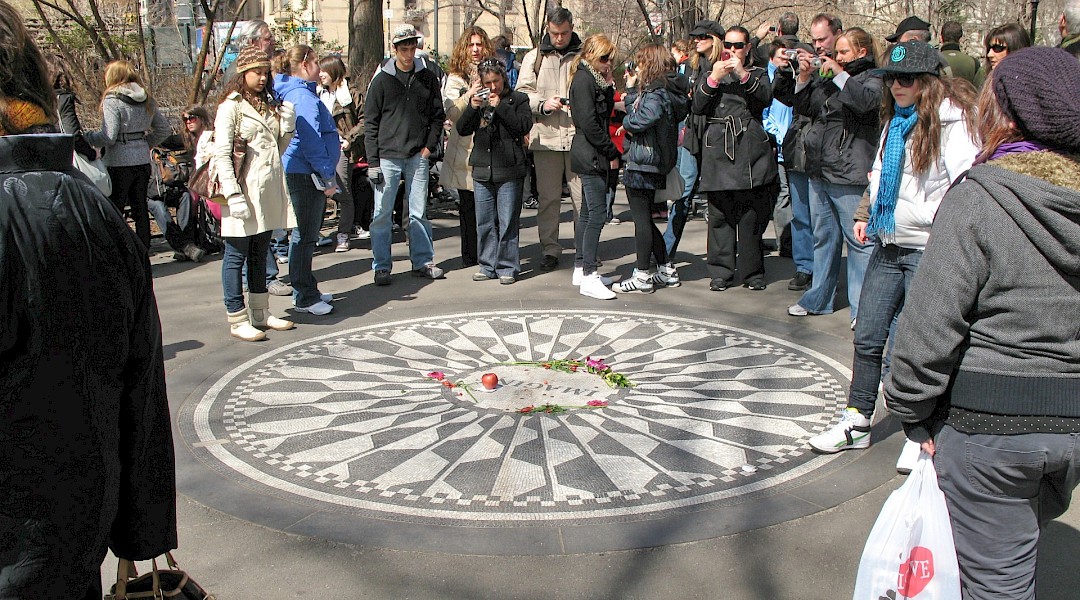 People gathered at the John Lennon Memorial. Unsplash:Robert Linder