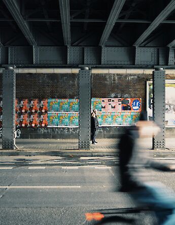 Biking under a bridge, Berlin, Germany. Madalena Veloso@Unsplash