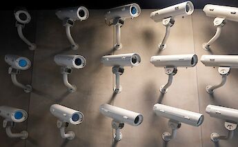 A wall with several security cameras mounted in different directions.