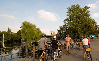 Listening to the tour guide by the river, Berlin, Germany. CC:Berlin on Bike