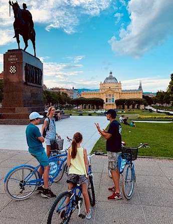 Cyclists stopped near the statue of King Tomislav on his namesake square in Zagreb.