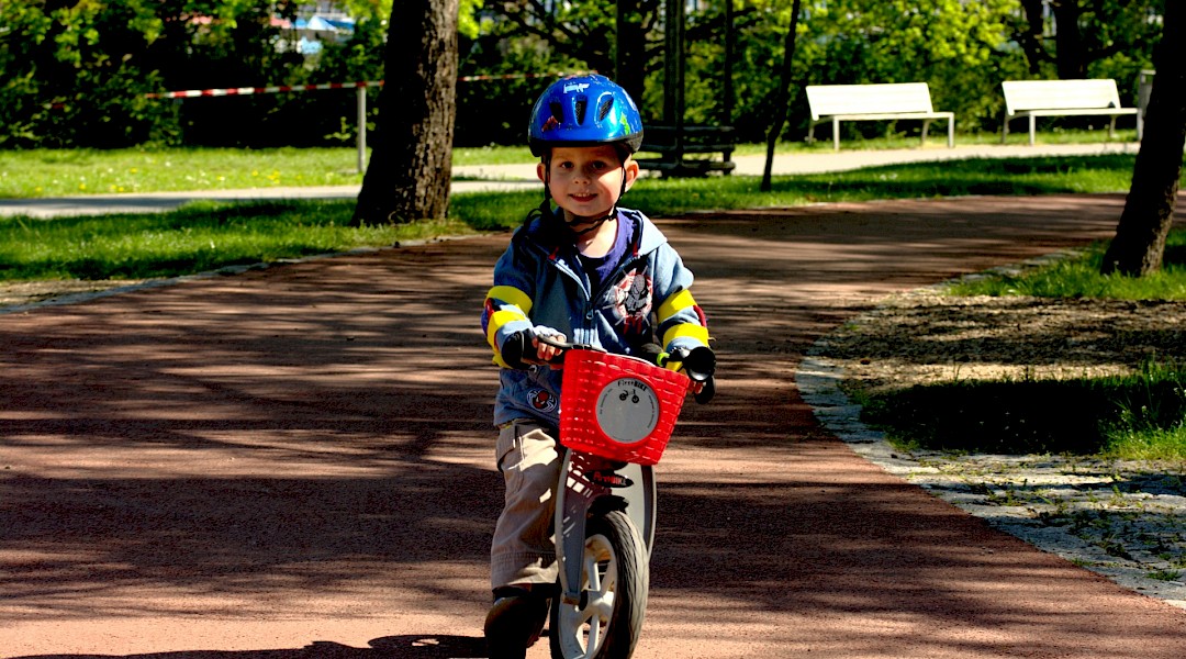 Child on a bike riding through a park, Zagreb, Croatia. Flickr