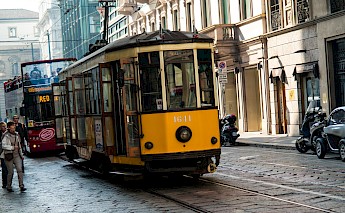Yellow tram passing through a city centre, Milan, Italy. Flickr:Martin V Morris