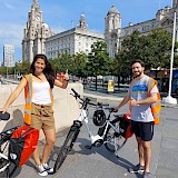 A couple in front of the Three Graces. Liverpool Cycle Tours