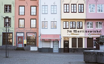Coloured shops, Cologne, Germany. Unsplash:Kevin Martin Jose