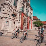 Biking past historic buildings, Munich, Germany. CC:Radius Tours