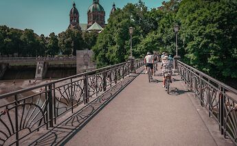 Cycling over a bridge, Munich, Germany. CC:Radius Tours