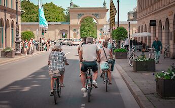 Cycling towards an arch, Munich, Germany. CC:Radius Tours